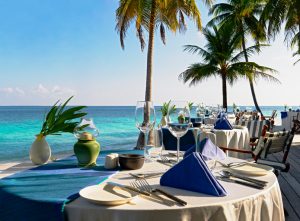 Open air restaurant table at beautiful blue water beach